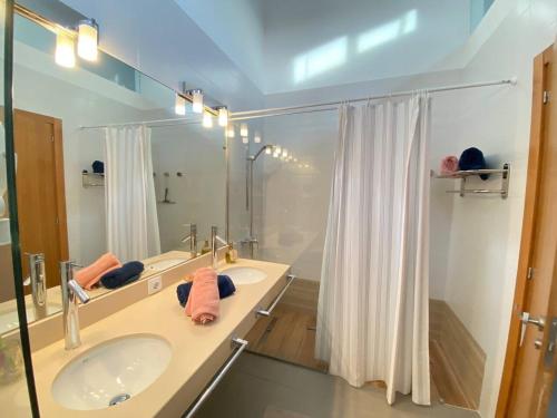 a bathroom with a sink and a mirror and a shower at Villa Majada Del Aceitun in Gran Tarajal