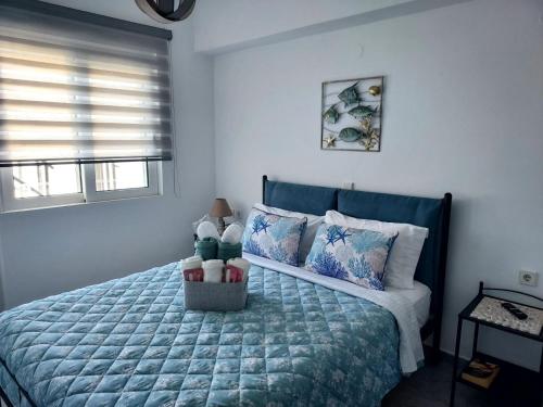 a bedroom with a bed with a blue comforter at Whisper wave in Haraki