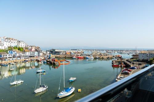 a group of boats docked in a harbor at Quayside Apartments, Brixham in Brixham