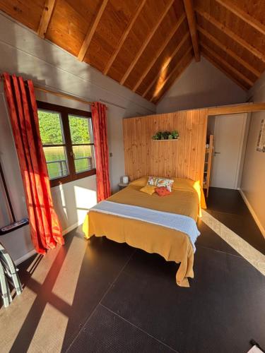 a bedroom with a bed in a room at Chalets flottants lac de Saint Étienne Cantalès in Saint-Gérons