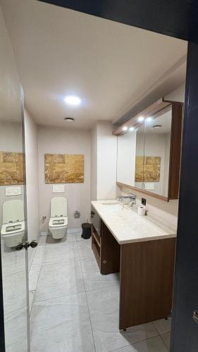 a bathroom with a toilet and a sink and mirror at PERLA SUİTES hotel in Istanbul