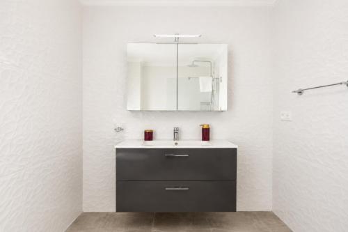 a bathroom with a sink and a mirror at Villa Portakal Blossom in Dalyan