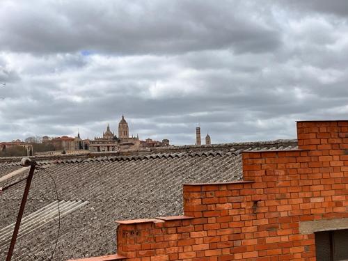 a view of a city from the roof of a building at HOSTAL MATILDAs in Segovia