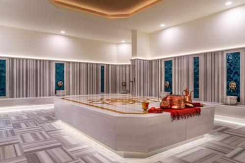 a large room with a tub in the middle at Trendy Perge Resort & Suites in Aksu