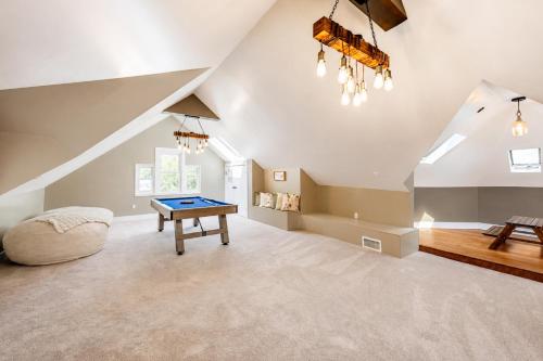 a room with a ping pong table in a attic at Pool House Near NYC FIFA Stay for Groups in Roselle