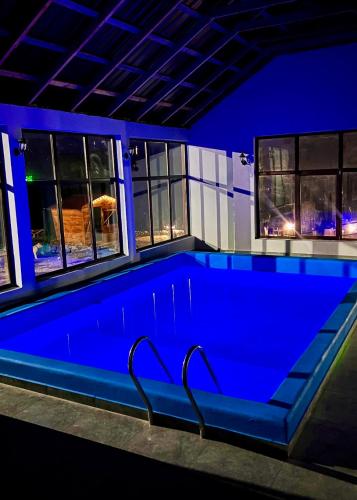 a swimming pool in a house at night at Shahunts Resort in Odzun