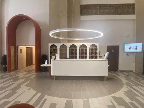 a lobby with a reception desk in a building at DOMITYS - Villa Molinis in Moulins
