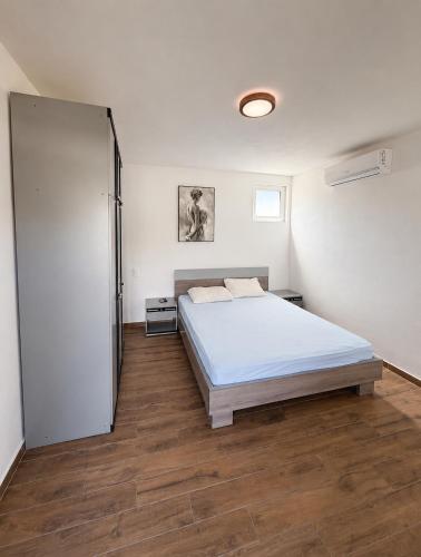 a bedroom with a bed and a sliding glass door at La Hacienda Percobic-Serenity & private pool in Bar