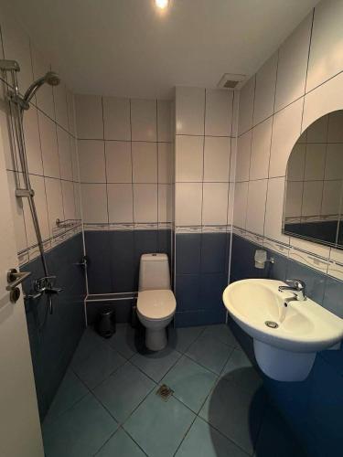 a bathroom with a toilet and a sink at Hotel Jasmine in Byala