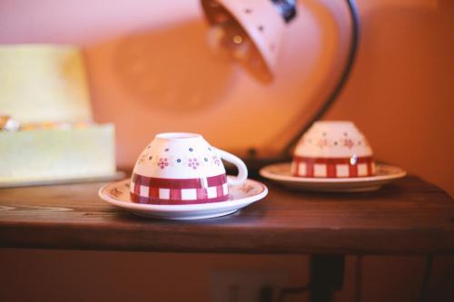 two tea cups and saucers sitting on a table at Guest House I Vicini di Cesare in Castelnuovo