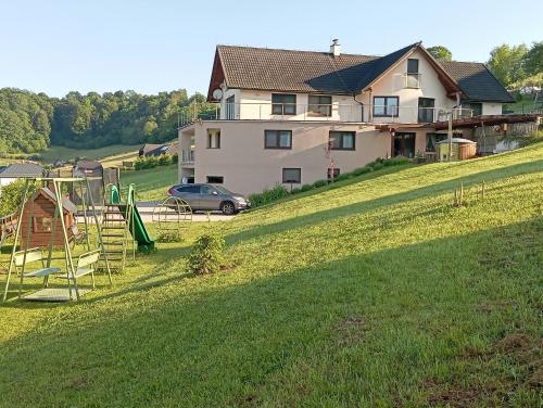 a house on a hill with a playground at Vila Veles in Dolný Kubín