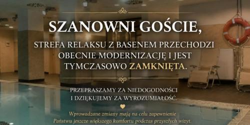 a sign on a window in a building with chairs at Great Polonia Silesian Economy Hotel in Katowice