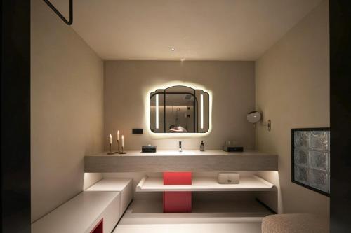 a bathroom with a sink and a mirror at Neyar Luxury and Tranquil Aesthetics Hotel-Prime Location,8-min Walk to Chunxi Road & Sino-Ocean Taikoo Li in Chengdu