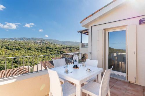 a white table and chairs on a balcony at Chic Residence Ea Bianca 1 Bed Apartment sleeps 4 in Cala Bitta