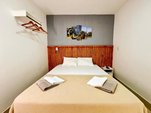 a bedroom with a bed with two towels on it at Casa Quebec - Apartamentos in São Miguel do Gostoso