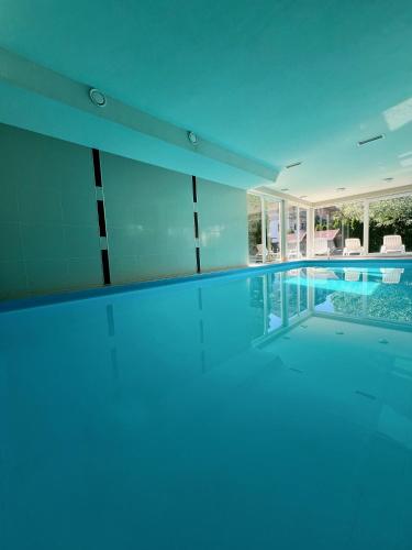 an empty swimming pool in a house at Wellness apartman in Siófok