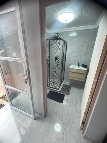 a bathroom with a shower and a sink at Abijah Ridgeview Studios in Roodepoort
