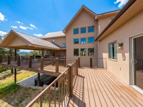 a house with a deck and a building at Avalon in Ruidoso