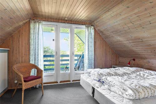 a bedroom with a large bed and a window at FY175-Asperup-Sommerlandsvej-4 in Asperup