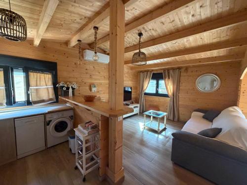 a log cabin with a kitchen and a living room at Casas Guemon in Zahora