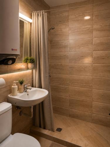 a bathroom with a sink and a toilet and a shower at Vesta Riviera - Free Parking in Golden Sands