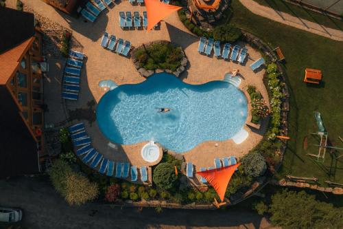 an aerial view of a swimming pool with a resort at Fiddler Lake 72 with Private spa, pool table & Pool in Mille-Isles