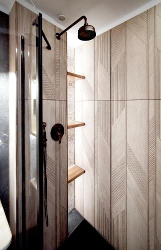 a shower with wooden walls and shelves in a bathroom at Czarny Jeleń in Zakopane