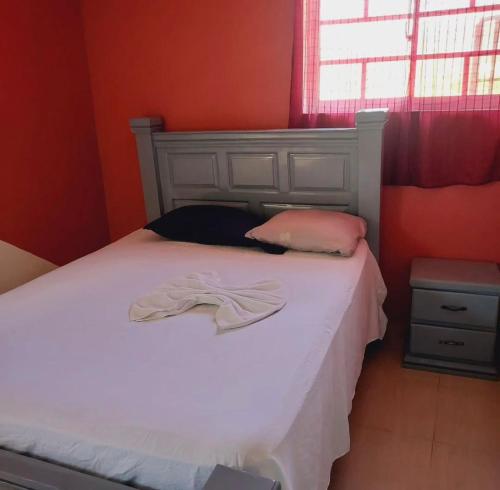 a bedroom with a bed with a robe on it at BaYO HOTEL in Vaudreuil