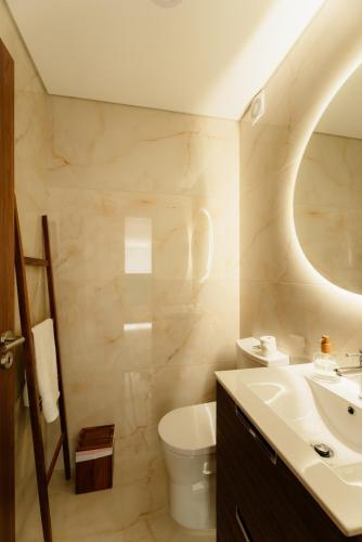 a bathroom with a sink toilet and a mirror at Serpa Pinto Village - Private Pool - by FERO in Cinfães