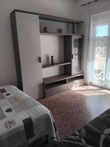 a bedroom with a bed and a large window at Eclisse quinto piano senza ascensore in Palermo