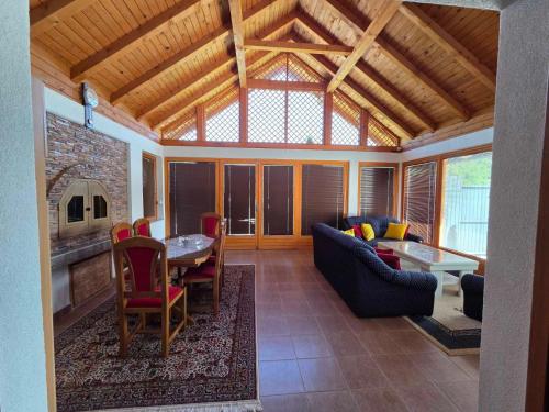 a living room with a couch and a table at Vikendica Twins in Donji Vakuf