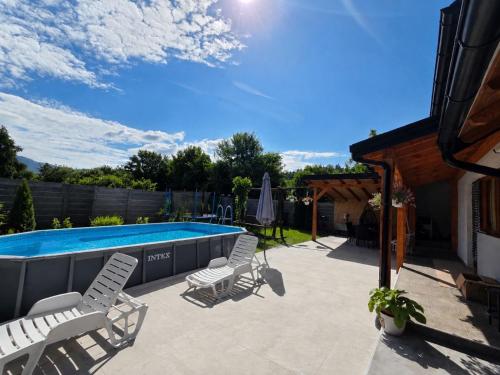 a patio with chairs and a swimming pool at Vikendica Twins in Donji Vakuf