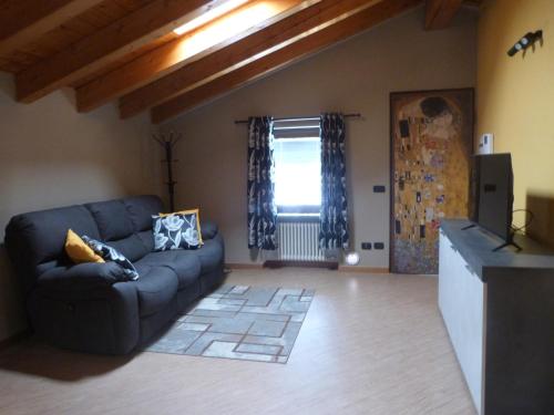 a living room with a blue couch and a window at Abri Douillet in Saint Marcel