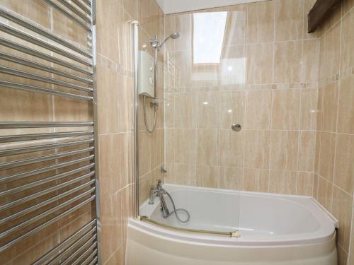 a bathroom with a shower and a bath tub at Tegfan in Newport