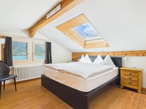 a bedroom with a large bed with a skylight at Guardian Gate Lodge in Iseltwald