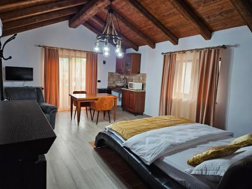 a bedroom with a bed and a dining room at Ale&Sere Housing in Jiblea Nouă