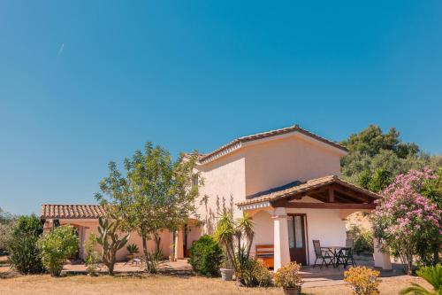 a house with a garden in front of it at Residenze Camboni in Castiadas