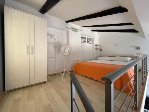 a bedroom with an orange bed and a closet at Downtown Apartments Pula in Pula