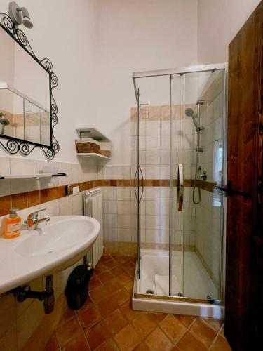 a bathroom with a glass shower and a sink at Casale Milleluci - Country House in Senigallia