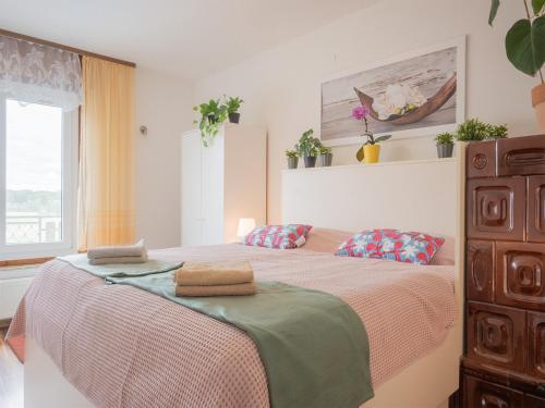 a bedroom with a bed with two pillows on it at Apartments Bukor with seasonal pool in Lukovica pri Domžalah
