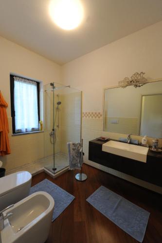 a bathroom with a tub and a sink and a mirror at La Torretta Rosa in La Spezia