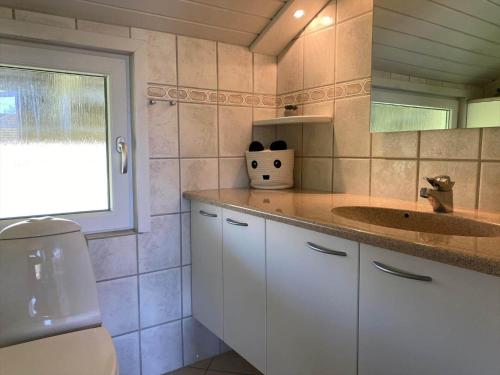 a bathroom with a sink and a toilet and a window at C11699-Hemmet-Vester-Faelled-70-A5 in Hemmet