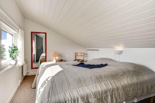 a bedroom with a large bed with a white ceiling at C11699-Hemmet-Vester-Faelled-70-A5 in Hemmet