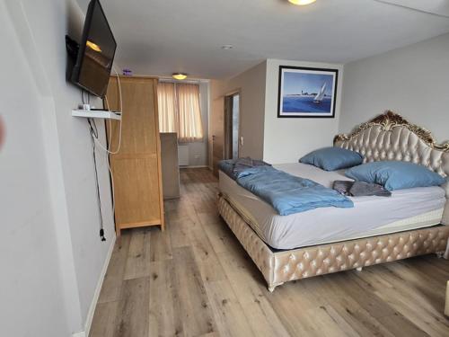 a bedroom with a bed and a flat screen tv at Bruchsal Herz in Bruchsal