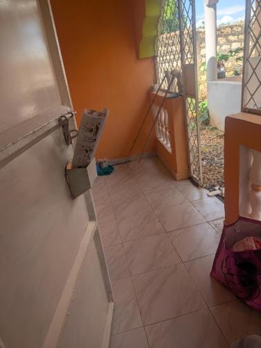 a room with a tiled floor with a door open at ADONAI Homes in Malindi