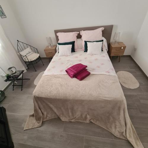 a large bed with two pillows on it in a bedroom at Sunny house in Pierrefeu-du-Var
