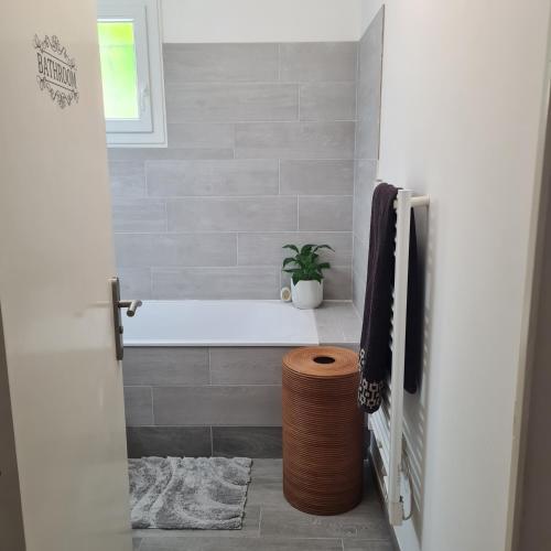 a bathroom with a tub and a potted plant at Sunny house in Pierrefeu-du-Var