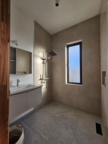 a bathroom with a sink and a window at Adam Duplex in Cap Malheureux