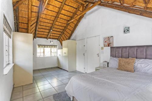 a bedroom with a large bed and a wooden ceiling at Mandy place in Sandown