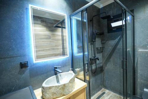 a bathroom with a sink and a shower at Sofia-Irini in Kalamaki